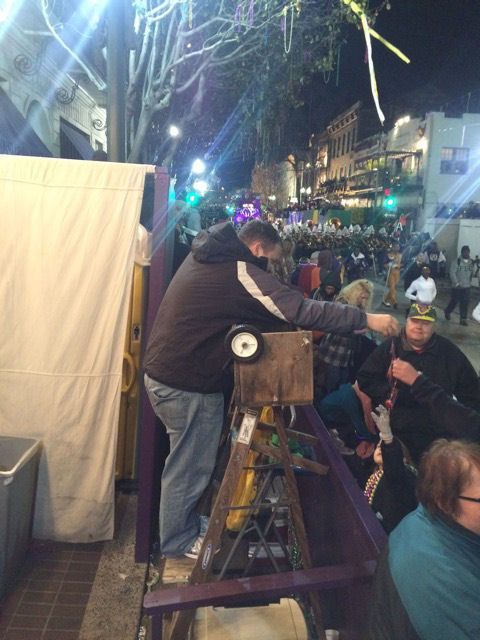 Mardi Gras Orpheus Slope Dad receiving beads